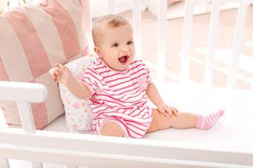 Fototapeta premium Portrait of cute little baby in crib at home