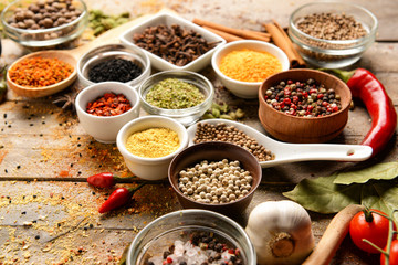 Different spices on wooden background