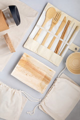 Obraz na płótnie Canvas Zero waste kit. Set of eco friendly bamboo cutlery, mesh cotton bag, reusable coffee tumbler and water bottle. Sustainable, ethical, plastic free lifestyle.