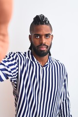 African american man with braids make selfie by camera over isolated white background with a...