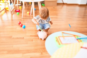 Adorable toddler playing around lots of toys at kindergarten