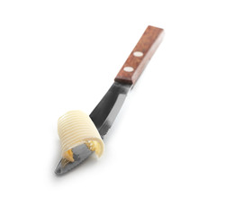 Knife with fresh butter on white background