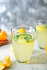 Glass of tasty lemonade on table