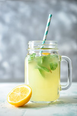 Tasty healthy lemonade in jar on table