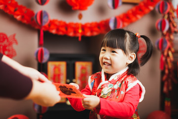 Chinese baby girl  traditional dressing up with a "FU"means "lucky" red envelope