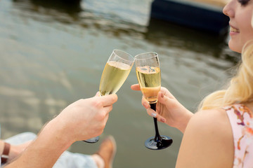 The guy with the girl raise glasses with champagne. Romantic date, love couple of a lovely couple
