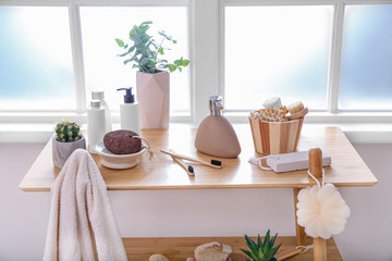 Body care cosmetics with accessories on rack in bathroom