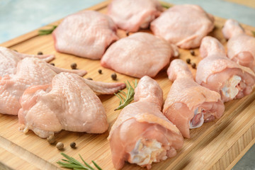 Raw chicken meat on wooden board