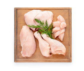 Board with raw chicken meat on white background