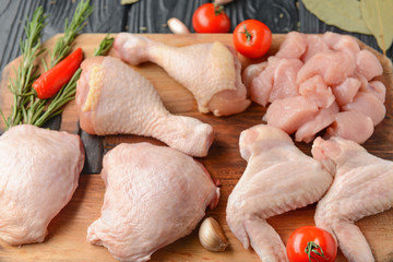 Raw chicken meat and vegetables on table