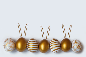 Easter eggs and easter bunny on white background with copy space. Easter background. Top view