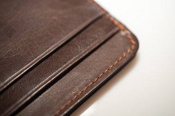 brown leather wallet on white background, purse close-up