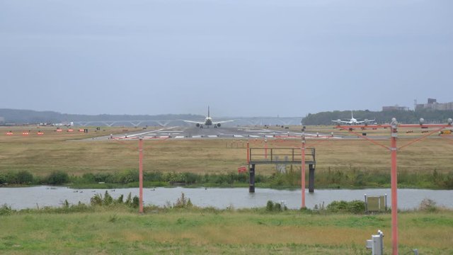 Classic shot of distant Jumbo Jet taxis and takes off at Reagan National Airport in Washington D.C. 