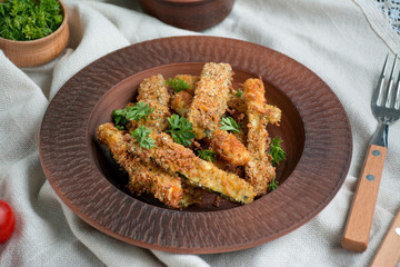Baked zucchini with cheese and breadcrumbs. Vegan food. Vegetarian cuisine. View from above. Light background.