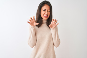 Beautiful chinese woman wearing turtleneck sweater standing over isolated white background smiling funny doing claw gesture as cat, aggressive and sexy expression