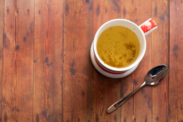 cup of chamomile, woman drinking cup of tea or coffee on wooden background