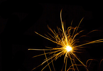 Blur abstract of yellow fireworks against black background, vivid color illustration