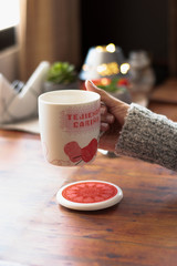 cup of chamomile, woman drinking cup of tea or coffee on wooden background