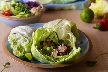 Stuffed iceberg lettuce cabbage leaves with chicken and vegetables. Wraps pockets of lettuce with chicken