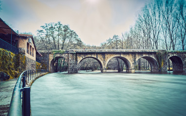 River with large water flow over a bridge in winter. The lake. Jaraíz de la Vera. Spain.