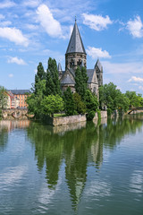 Fototapeta na wymiar Temple Neuf (New Temple), a Protestant city church in Metz, France. View from a bridge across the Moselle river. The church was built in 1901-1904.
