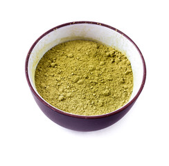 Dry Matcha Tea in a clay tea cup isolated on a white background.