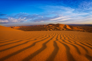 Desert landscape near Merzouga, small village in Morocco, known for its proximity to Erg Chebbi, tourists visiting Morocco, described as a desert theme park, and the Erg Chebbi as a wonderland of sand