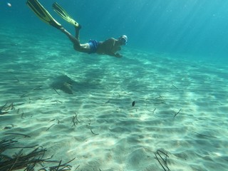 underwater man snorkeling in the sea withcrystal-clear waters concept of holiday relax summer beach...