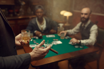 Three poker players sitting at the table, casino