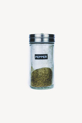 SPICE PEPPER IN GLASS BOTTLE ON WHITE BACKGROUND	