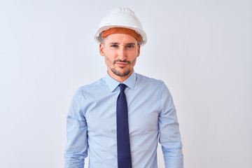 Young business man wearing contractor safety helmet over isolated background skeptic and nervous, frowning upset because of problem. Negative person.