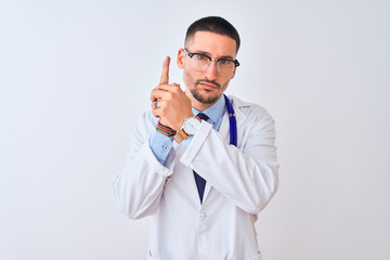 Young doctor man wearing stethoscope over isolated background Holding symbolic gun with hand gesture, playing killing shooting weapons, angry face