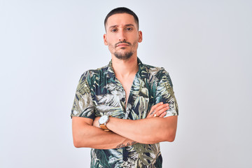 Young handsome man wearing Hawaiian summer shirt over isolated background skeptic and nervous,...
