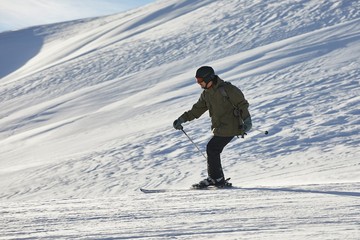 Fototapeta na wymiar Skiers sliding down a snowy slope