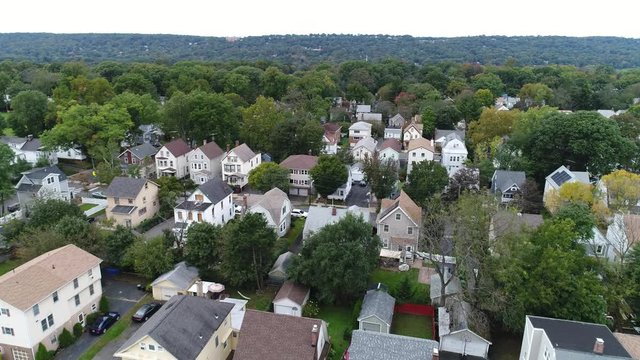 A suburban town outside of a city, aerial shot in 4k