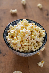 bowl of popcorn on wooden surface