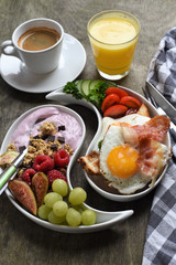 Colorful, healthy and tasty breakfast ingredients  on wooden table