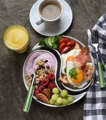 Colorful, healthy and tasty breakfast ingredients  on wooden table