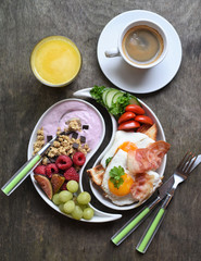 Fototapeta na wymiar Colorful, healthy and tasty breakfast ingredients on wooden table