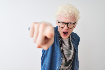 Young albino blond man wearing denim shirt and glasses over isolated white background pointing displeased and frustrated to the camera, angry and furious with you