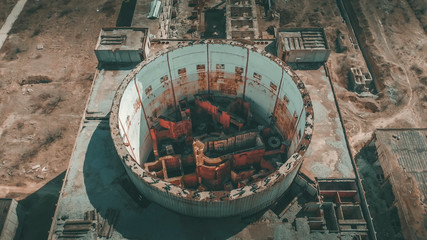 Aerial top view of abandoned and ruined Nuclear Power Plant. Large industrial construction with...