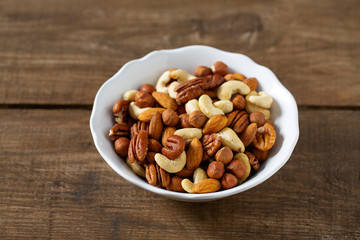 mixed nuts on wooden surface