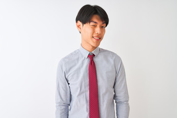 Chinese businessman wearing elegant tie standing over isolated white background winking looking at the camera with sexy expression, cheerful and happy face.