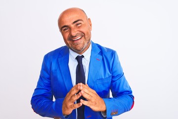 Middle age businessman wearing suit standing over isolated white background Hands together and fingers crossed smiling relaxed and cheerful. Success and optimistic