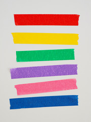 Various ripped pieces of multi color masking tape combinations on a White Background. Place for...