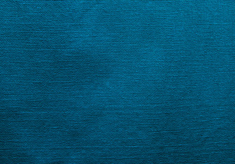 Blue fabric texture. Background of blue fabric with seam and holes.