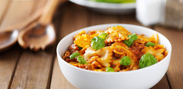 farfalle pasta with basil and beef in tomato sauce with copysapce