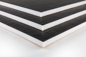 Teflon-coated sound insulation board.Rubber sheet. Piece of square plastic for industrial.