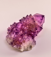 Amethyst stone isolated. Different amethyst crystal formation with one big point. Amethyst is one of the most using healing crystals with its positive energy. Absorbs negative energy in home or aura .