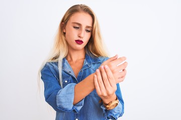 Young beautiful woman wearing casual denim shirt standing over isolated white background Suffering pain on hands and fingers, arthritis inflammation